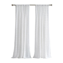 White chenille curtain panels on a rod, featuring soft vertical stripe texture