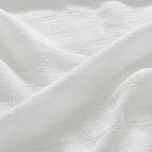White chenille fabric close-up with fine woven texture and subtle sheen