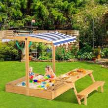 Wooden outdoor sandbox with picnic table, striped canopy, and two side benches