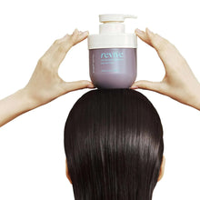 Healing Bird Revive protein deep hair mask jar held above head by hands