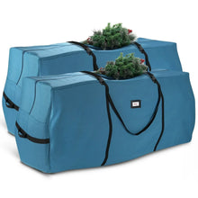 Pair of blue Christmas tree storage bags with black carry handles and straps, each with a tree
