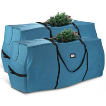 Blue Christmas tree storage bag with black straps and tree stored on top