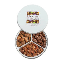 Round pecan tin with lid open, filled with roasted salted and chocolate-coated pecans