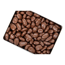 Chocolate-covered pecans in metal tray, rounded pieces coated in dark chocolate
