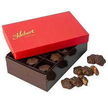 Boxed milk chocolate caramels with cranberry and cashew, with loose pieces