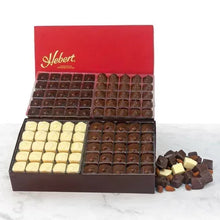 Hebert chocolate assortment box open with dark and white compartments plus broken pieces