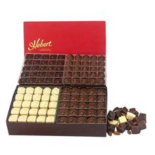 Opened Hebert chocolate assortment box with rows of dark and white chocolates