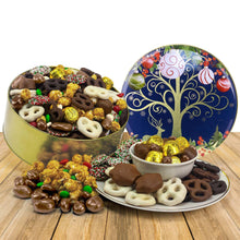 Open holiday cookie tin with assorted chocolate candies and cookies on tray
