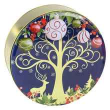 Round holiday cookie tin lid with blue illustrated tree, ornaments, and snowy scenes