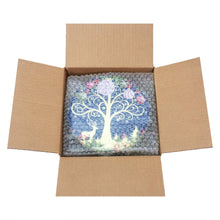 Holiday cookie tin in kraft cardboard box, lid shows blue tree with ornaments