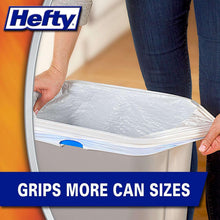 Kitchen trash bag in a bin, white bag with hands lifting the rim