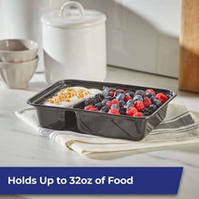 Two-compartment food storage containers with lids, black, filled with fruit and grains