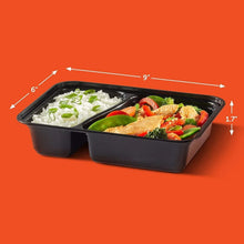Two-compartment food storage containers with lids, black, filled with meals, 2 sections
