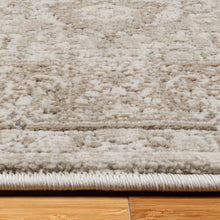 Beige area rug texture close-up with low pile and subtle fringe at edge