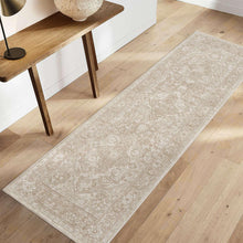 Beige area rug with ornate medallion pattern and distressed texture, rectangular.
