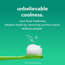 Fluoride-free spearmint toothpaste on white toothbrush bristles