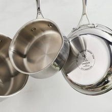 Stainless steel tri-ply pot and lid with close-up of interior base