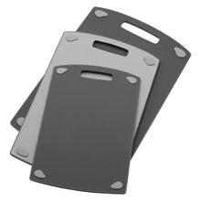 Stacked gray cutting boards with handle cutouts, three-piece set