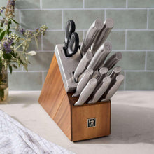 Self-sharpening knife set with acacia block holding gray-handled knives and shears
