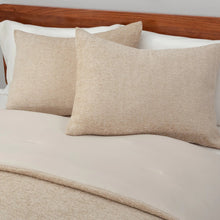 Beige comforter with two chenille herringbone accent pillows on top