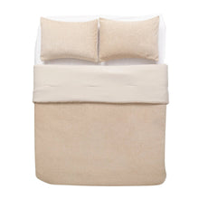 Beige comforter set with two matching pillows, neatly folded