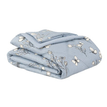 Folded blue down alternative blanket with white floral and butterfly pattern
