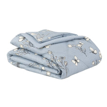 Light blue down alternative blanket with gold butterfly and flower print, neatly folded.