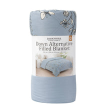 Rolled blue down alternative blanket in retail packaging with floral print