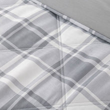 Grey and white plaid down alternative blanket with quilted stitching close-up
