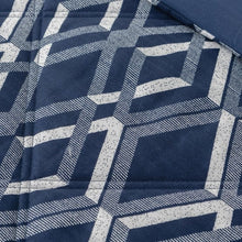 Close-up of dark blue and white geometric crosshatch blanket fabric