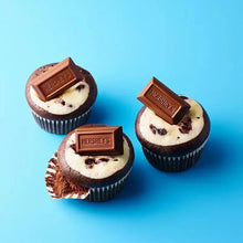 Mini chocolate candy bar toppers on small cupcakes
