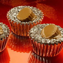 Miniature peanut butter cups with dark chocolate shells and crumb coating