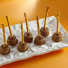 Miniature peanut butter cups with dark chocolate shells and filling on top