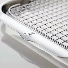 Stainless sheet pan with wire rack, close-up of side edge and embossed mark