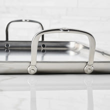 Stainless steel griddle pan with two lifting handles and brushed metal body