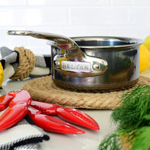 Stainless steel butter warmer saucepan with Hestan logo on handle