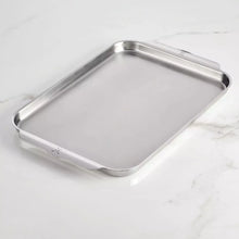 Rectangular stainless steel sheet pan with shallow sides and rolled rim