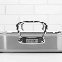 Stainless steel roasting pan with front loop handles and brushed metal rim