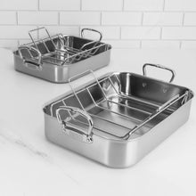 Stainless steel roasting pan with wire rack, plus another pan behind it