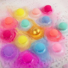 Foaming bath water with floating mini bath bomb caps in bright colors