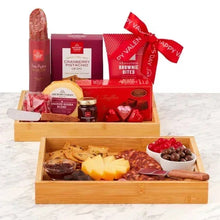 Valentine gift set with ribbon sweets and a wooden tray of cheese, sausage, and red candy hearts