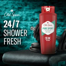 Red body wash bottle with Pure Sport label on dark towel