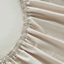 Cream fitted sheet edge with gathered elastic seam