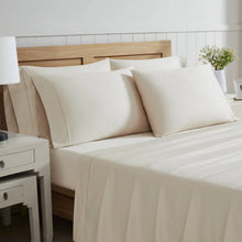 Highland Park sheet set on bed with cream pillowcases and fitted sheets