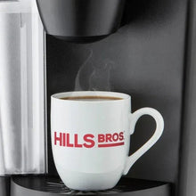 White Hills Bros. mug of coffee on a coffee machine