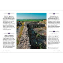 Hardcover history book open to landscape photo with two text columns