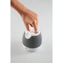 mybaby SoundSpa baby white and dark gray sound projector with hand pressing the top
