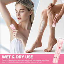 Pink electric body trimmer with dual shaving heads, held in hand for grooming