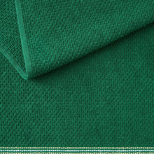 Green kitchen towel with textured weave and folded edge seam.