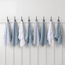 Blue and white holiday kitchen towels with snowflakes, stripes, and textured weaves